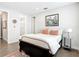 A stylish bedroom with a queen bed, an artful picture, and ensuite bathroom, complete with hardwood floors at 4215 W North A St # 3, Tampa, FL 33609