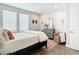 Cozy bedroom with hardwood floors, natural light, accent chairs, and a comfortable bed at 4215 W North A St # 3, Tampa, FL 33609