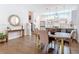 Dining room featuring a wood table with gold legs, hardwood floors, and an adjacent kitchen at 4215 W North A St # 3, Tampa, FL 33609