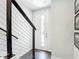 Bright entryway with a white front door, modern black railing, and sleek tile flooring at 4215 W North A St # 3, Tampa, FL 33609