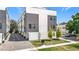Contemporary townhome with gray and white exterior, attached garages, and landscaping at 4215 W North A St # 3, Tampa, FL 33609