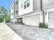 View of the modern townhouse with attached garages and a paved driveway at 4215 W North A St # 3, Tampa, FL 33609
