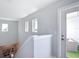 Bright hallway with small windows, a glass door leading to an outdoor seating area, and staircase access at 4215 W North A St # 3, Tampa, FL 33609