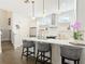 Well-lit kitchen with white cabinets, stainless steel appliances, and a breakfast bar area with chairs at 4215 W North A St # 3, Tampa, FL 33609