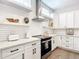 Well-lit kitchen showcasing white cabinets, quartz countertops, and stainless steel appliances at 4215 W North A St # 3, Tampa, FL 33609