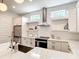 Bright kitchen featuring stainless appliances, quartz countertops, and white subway tile backsplash at 4215 W North A St # 3, Tampa, FL 33609