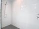 Modern shower featuring white tile walls, a handheld shower head, and patterned tile flooring at 4215 W North A St # 3, Tampa, FL 33609
