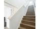 Elegant staircase with stained wood steps, contrasting white risers, and freshly painted walls at 4215 W North A St # 3, Tampa, FL 33609