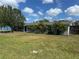 Single-story home with a well-manicured lawn, mature trees, and a classic Florida style at 432 51St St W, Palmetto, FL 34221