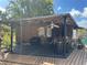 Outdoor shed with overhead lighting and a fan, plus seating area and decorative elements at 432 51St St W, Palmetto, FL 34221
