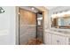 Bathroom featuring a tiled walk-in shower, single sink vanity, tile flooring, and recessed lighting at 4396 5Th Isle Dr, Hernando Beach, FL 34607