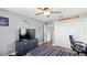 Comfortable bedroom featuring wood floors, desk area, closet, and ceiling fan at 4396 5Th Isle Dr, Hernando Beach, FL 34607