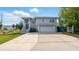 Two-story home featuring a two car garage and a large concrete driveway at 4396 5Th Isle Dr, Hernando Beach, FL 34607
