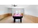Spacious game room with a pink billiard table, ceiling fan, and french doors at 4396 5Th Isle Dr, Hernando Beach, FL 34607