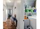 View of a hallway with wood floors, leading to a bedroom, and a laundry room with a washer and dryer at 4396 5Th Isle Dr, Hernando Beach, FL 34607