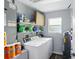 Efficient laundry room with a washer, dryer, and ample storage shelving at 4396 5Th Isle Dr, Hernando Beach, FL 34607