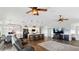 Spacious living room with an open floor plan, hardwood floors, a central kitchen island, and ample natural light at 4396 5Th Isle Dr, Hernando Beach, FL 34607