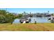 View of a canal with multiple boats docked at private piers with nearby homes in the background at 4396 5Th Isle Dr, Hernando Beach, FL 34607