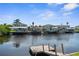 Scenic waterfront view featuring homes with private docks and boat lifts on a sunny day at 4396 5Th Isle Dr, Hernando Beach, FL 34607