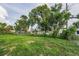 Expansive backyard surrounded by lush greenery, mature trees and a chain link fence at 4920 Zodiac Ave, Holiday, FL 34690