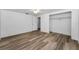 Bright bedroom features hardwood flooring, closet, and a ceiling fan at 4920 Zodiac Ave, Holiday, FL 34690