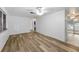 Spacious room showcases hardwood floors, light-colored walls, and a view into an adjacent room at 4920 Zodiac Ave, Holiday, FL 34690