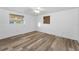 Bright bedroom features hardwood flooring, ceiling fan, and a double window at 4920 Zodiac Ave, Holiday, FL 34690