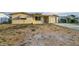 Charming single-story home featuring a light-colored exterior, attached garage, and front yard at 4920 Zodiac Ave, Holiday, FL 34690