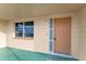 A welcoming front porch featuring a window and an orange front door at 4920 Zodiac Ave, Holiday, FL 34690