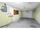 Spacious garage featuring a garage door, work area, and electrical panel at 4920 Zodiac Ave, Holiday, FL 34690