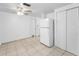 Well-lit kitchen features a white refrigerator, tiled floors, and access to other rooms at 4920 Zodiac Ave, Holiday, FL 34690