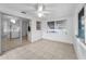 Bright living room features tile flooring, ceiling fan, and sliding doors to another room at 4920 Zodiac Ave, Holiday, FL 34690