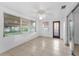 Bright living room features tile flooring, ceiling fan, and access to the exterior at 4920 Zodiac Ave, Holiday, FL 34690