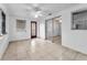 Bright living room features tile flooring, ceiling fan, and sliding doors to another room at 4920 Zodiac Ave, Holiday, FL 34690
