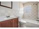 Clean bathroom with tiled walls, a sink, toilet, and shower-tub combination at 5111 Eldorado Dr, Tampa, FL 33615
