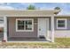 Charming single-story home featuring a welcoming front porch, neutral paint, and manicured landscaping at 5111 Eldorado Dr, Tampa, FL 33615