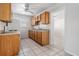 Well-lit kitchen with wooden cabinets, laminate countertops, and essential appliances at 5111 Eldorado Dr, Tampa, FL 33615