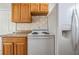 Well-lit kitchen featuring wooden cabinets, a white range, and a refrigerator at 5111 Eldorado Dr, Tampa, FL 33615