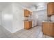 Efficient kitchen layout with wood cabinetry, white appliances, and tile flooring for easy cleaning at 5111 Eldorado Dr, Tampa, FL 33615