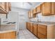 Functional kitchen with ample wood cabinets, white appliances, and a window for natural light at 5111 Eldorado Dr, Tampa, FL 33615
