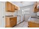 Cozy kitchen featuring ample wood cabinets, laminate counters, and essential appliances at 5111 Eldorado Dr, Tampa, FL 33615