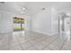 Bright living room featuring tile floors and sliding glass doors to backyard at 5111 Eldorado Dr, Tampa, FL 33615