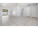 Bright living room featuring tile flooring, ceiling fans, and sliding glass doors to the backyard at 5111 Eldorado Dr, Tampa, FL 33615