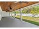 Covered patio overlooking fenced backyard with ceiling fans for outdoor comfort at 5111 Eldorado Dr, Tampa, FL 33615