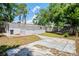 View of the home's backyard featuring a white exterior and concrete driveway at 5119 Gateway Dr, Tampa, FL 33615