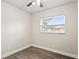 Well-lit bedroom featuring a ceiling fan, wood-look flooring, and a window with natural light at 5119 Gateway Dr, Tampa, FL 33615