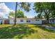 Charming single-story home with a well-maintained front lawn and mature trees providing ample shade at 5119 Gateway Dr, Tampa, FL 33615