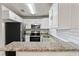 Modern kitchen with stainless steel appliances, granite countertops, and sleek subway tile backsplash at 5119 Gateway Dr, Tampa, FL 33615