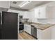 Well-equipped kitchen with granite countertops, stainless steel appliances, and a stylish subway tile backsplash at 5119 Gateway Dr, Tampa, FL 33615