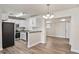 Open-concept kitchen with granite counter tops and dining area features stainless steel appliances and fixtures at 5119 Gateway Dr, Tampa, FL 33615